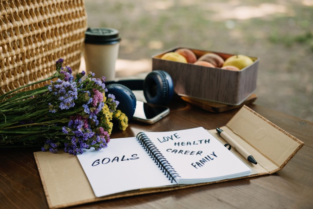 New Years Resolutions Goals motivational phrase in open notebook on the table. Outdoor still life with My Goals motivational text. Self-development and motivation.